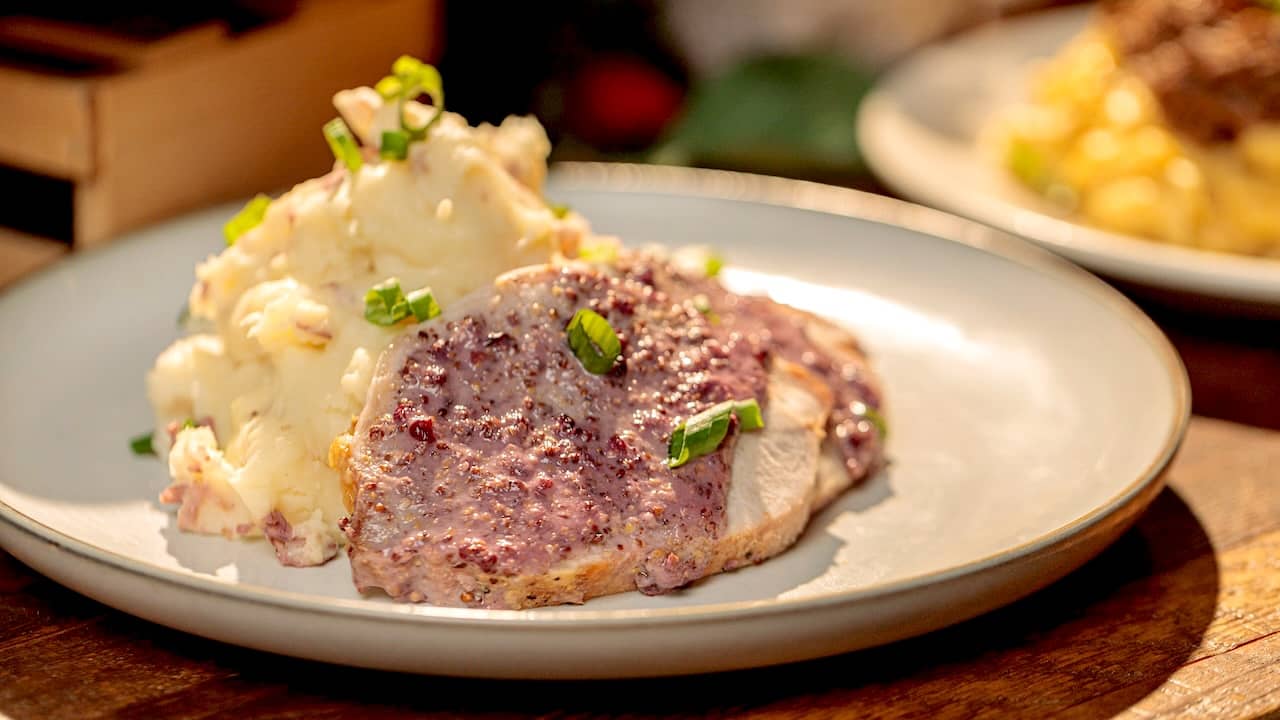 Pork loin slices over mashed potatoes with a boysenberry mustard sauce